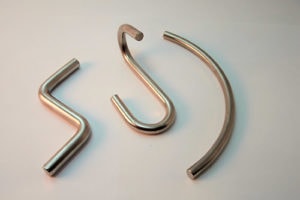 These larger wire forms made of basic steel wire have diameters of .250 and .312. Formed on our Nilson S4 fourslide.