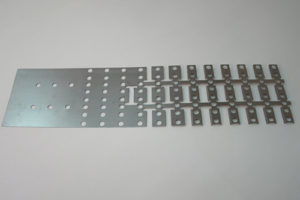 Example of a progressive die strip from our punch press