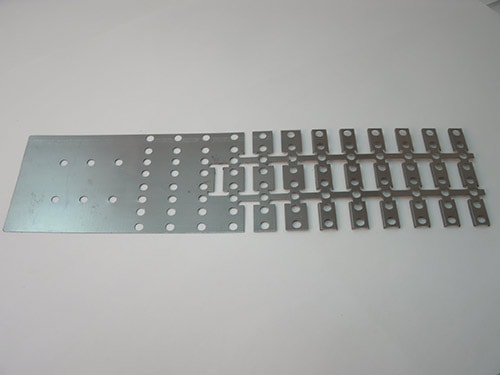 Example of a progressive die strip from our punch press